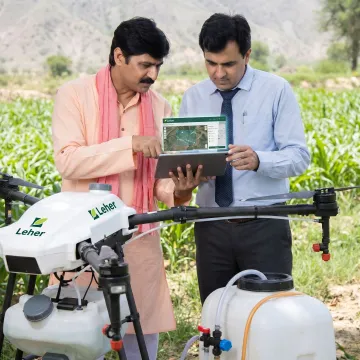 Farmer reviewing drone spraying features