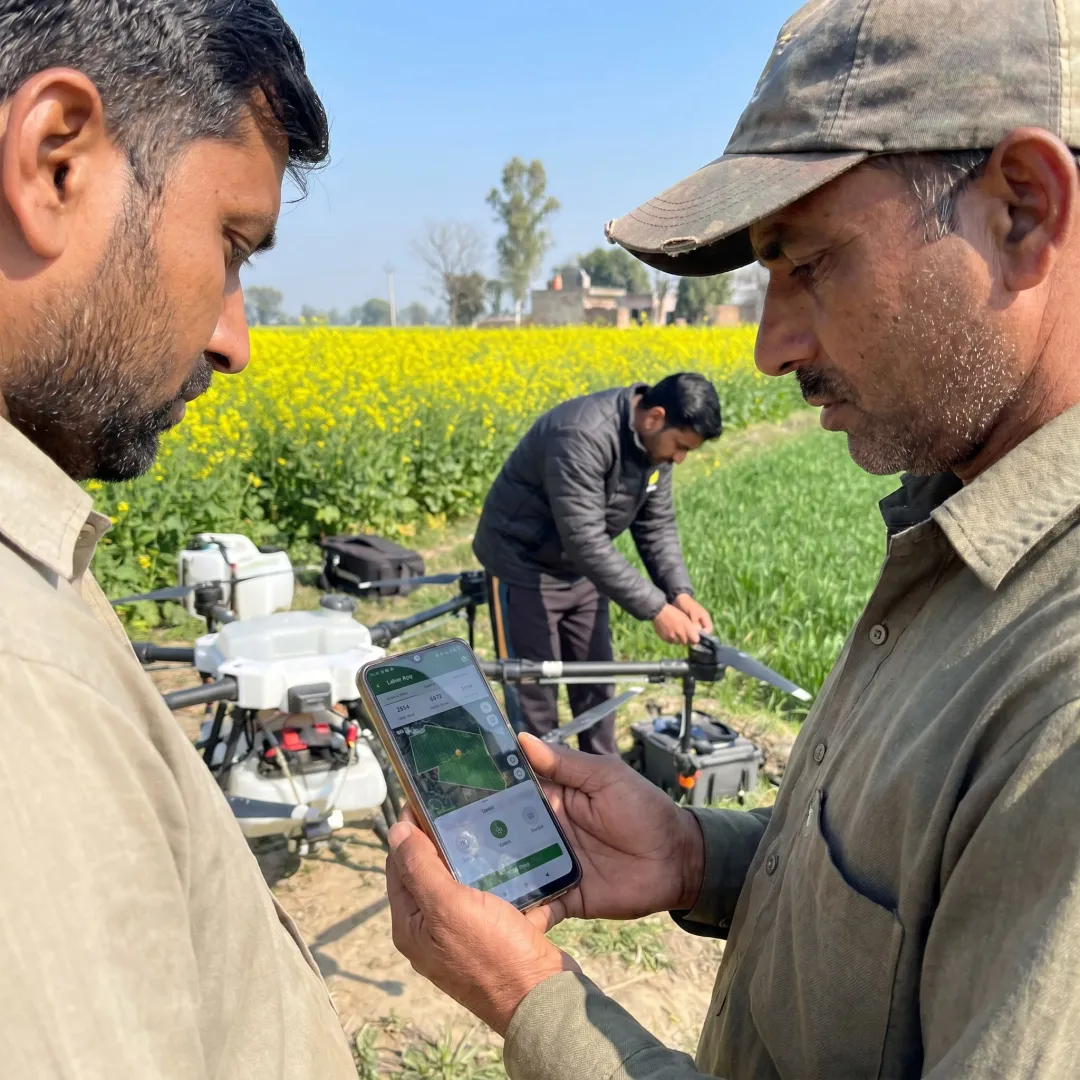 Farmer booking drone spraying through an app