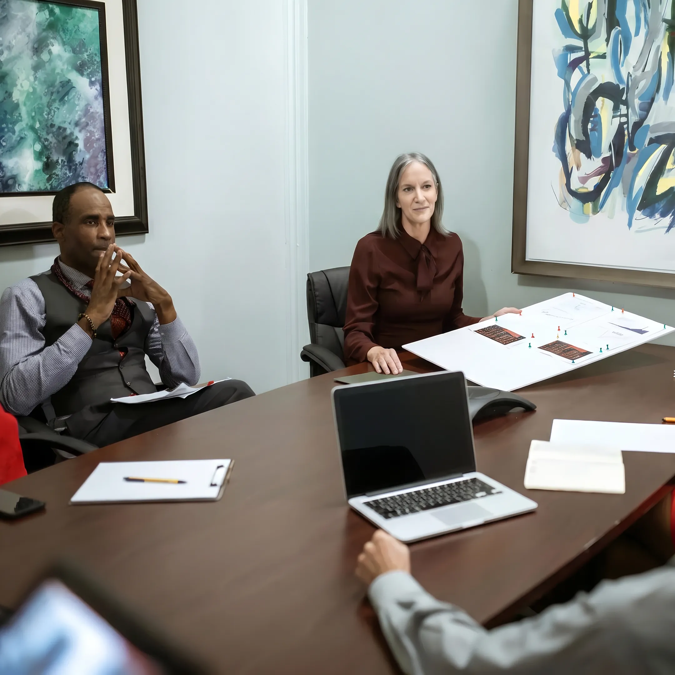 Business owner reviewing a $100,000 funding plan with a financial specialist