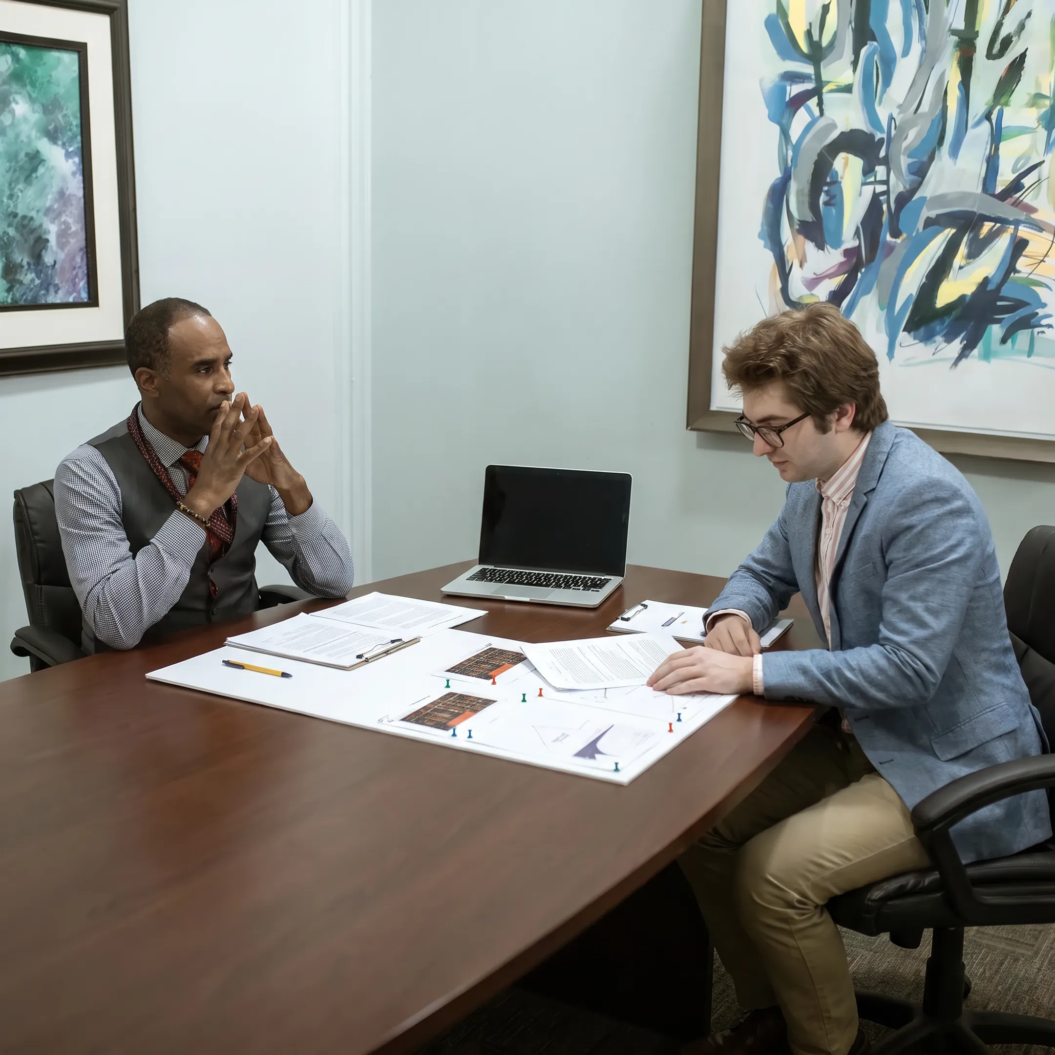 Michigan real estate investor reviewing private loan documents with a funding specialist