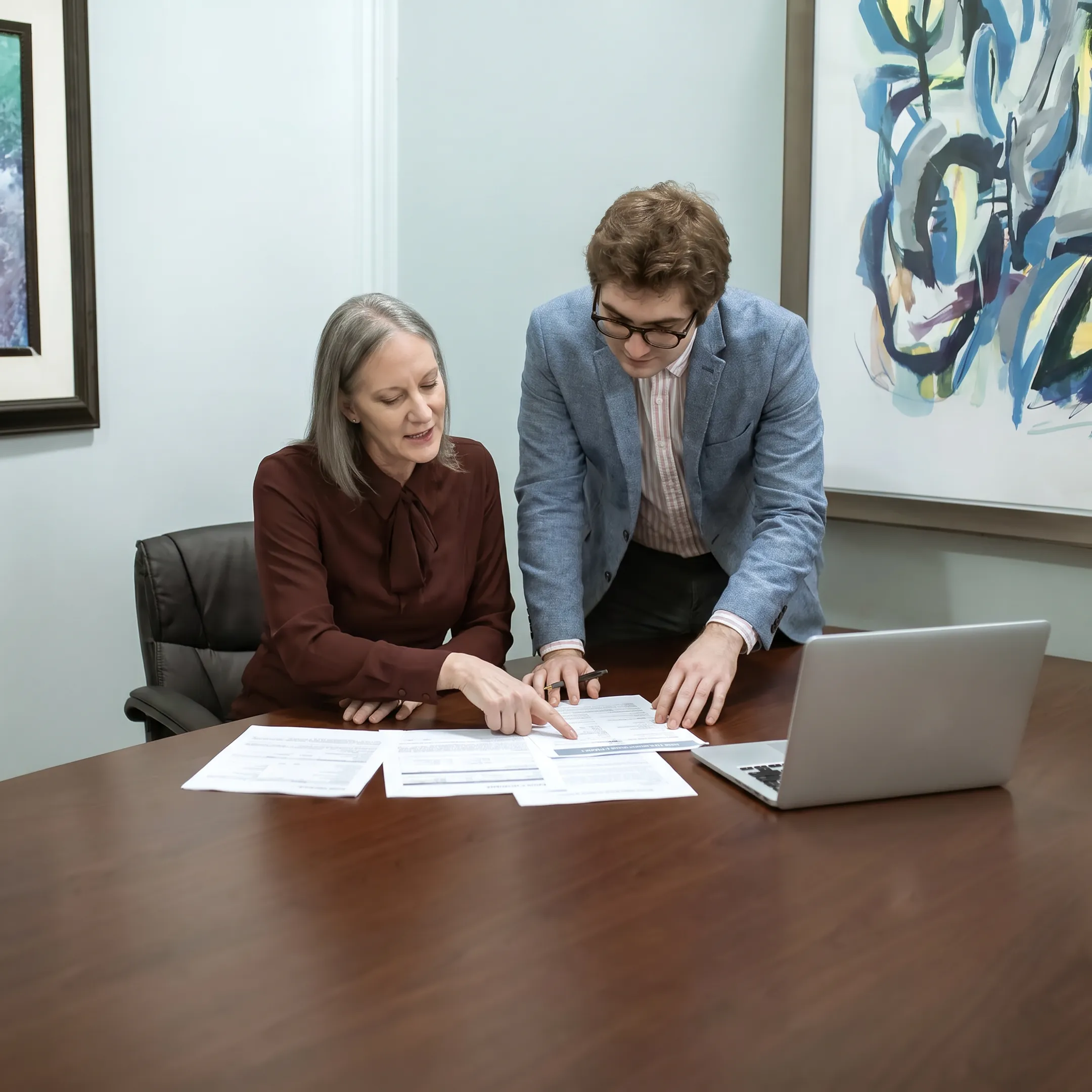 Business owner reviewing SBA loan documents with funding specialist