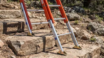 Level-EZE automatic ladder leveler self-adjusting on uneven stepped terrain