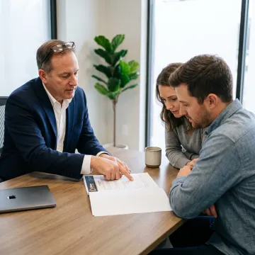 Loan officer reviewing mortgage options with homebuyers