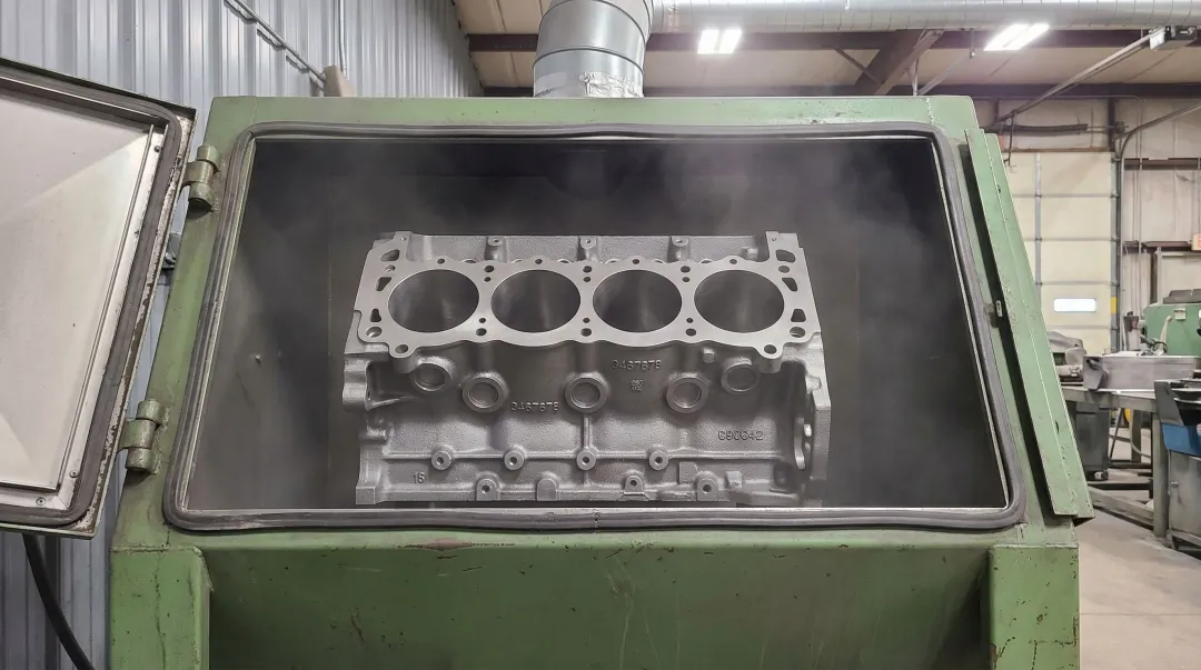 Engine block abrasive blast cleaning process in automotive machine shop