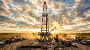 Oil and gas rig construction site with heavy equipment and machinery