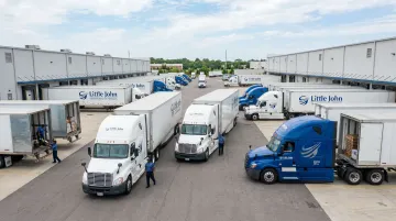 Little John Transportation Services dedicated fleet trucks branded with shipper livery at facility