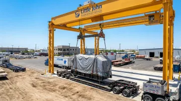 Heavy crane transferring oversized industrial cargo at Laredo transload facility