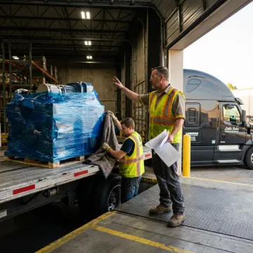 Furniture delivery team coordinating a careful shipment