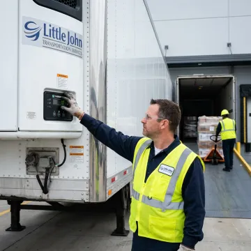 Technician checking reefer trailer temperature controls
