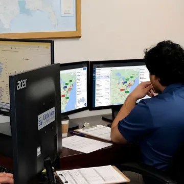 Freight dispatcher tracking full truckload shipment