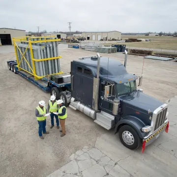 Heavy equipment loading onto specialized trailer