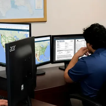 Logistics coordinator tracking white glove delivery