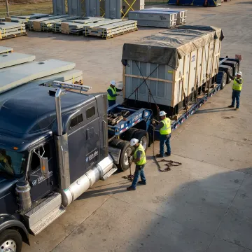 Heavy machinery loaded on specialized trailer for transport