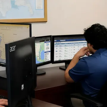 Freight coordinator reviewing reefer shipment details