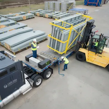 Flatbed truck being loaded with industrial freight