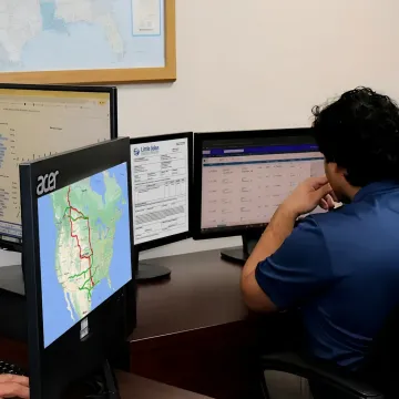 Freight operations team coordinating industrial shipment tracking