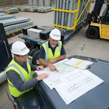 Flatbed freight team planning an oversized shipment route