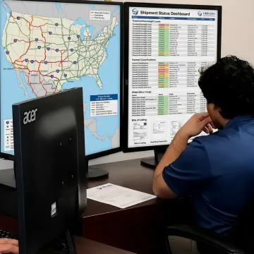 Logistics coordinator tracking a white glove freight delivery