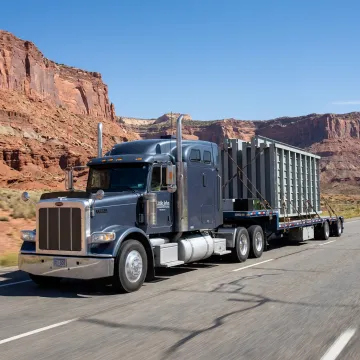 Flatbed truck hauling industrial equipment in Utah