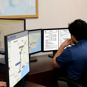 Heavy haul route planning team reviewing oversized freight plans