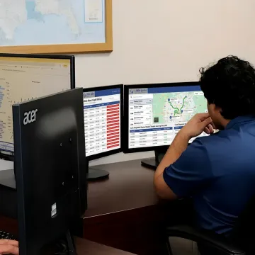 Freight specialist coordinating white glove delivery tracking