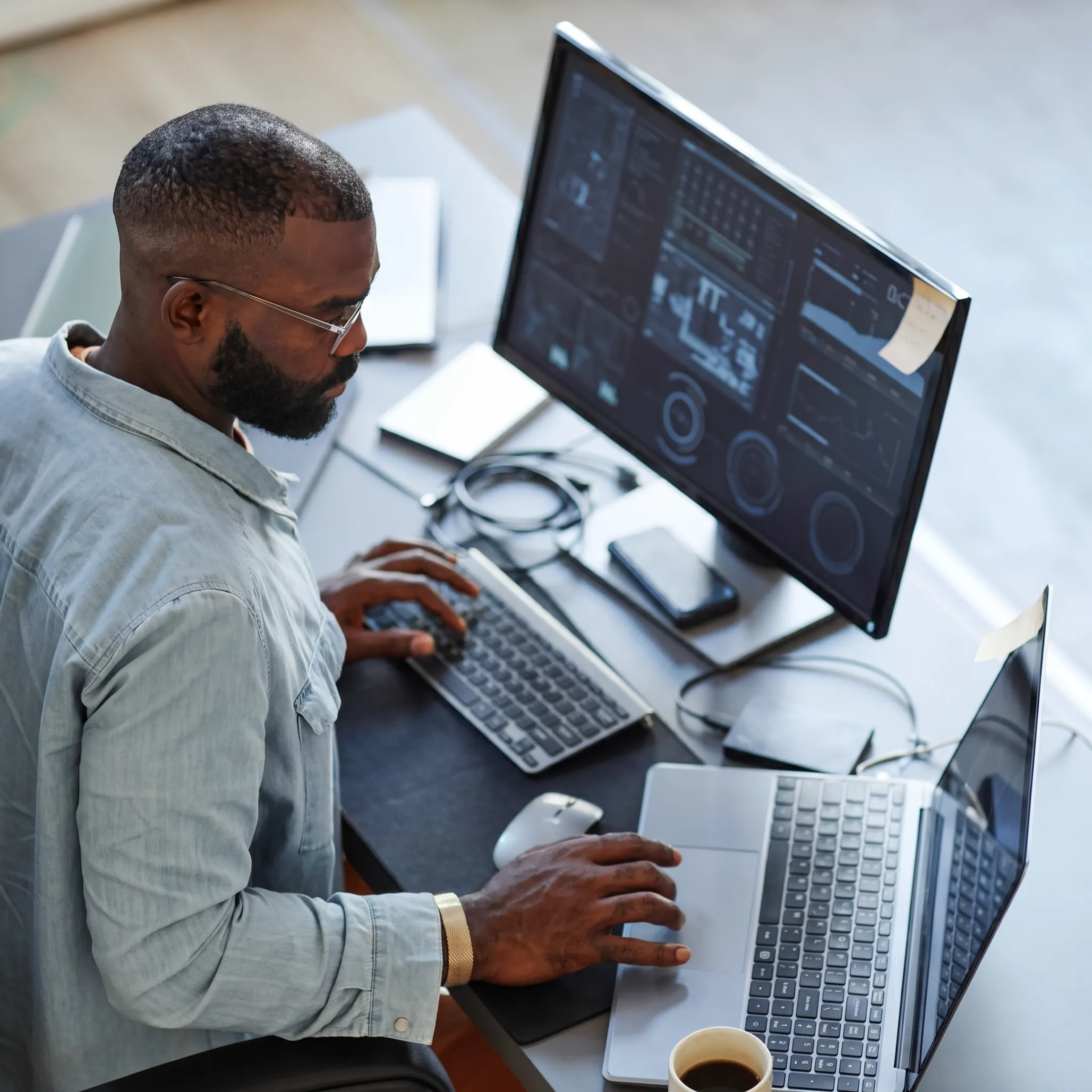 Technician monitoring business network systems in a modern operations center