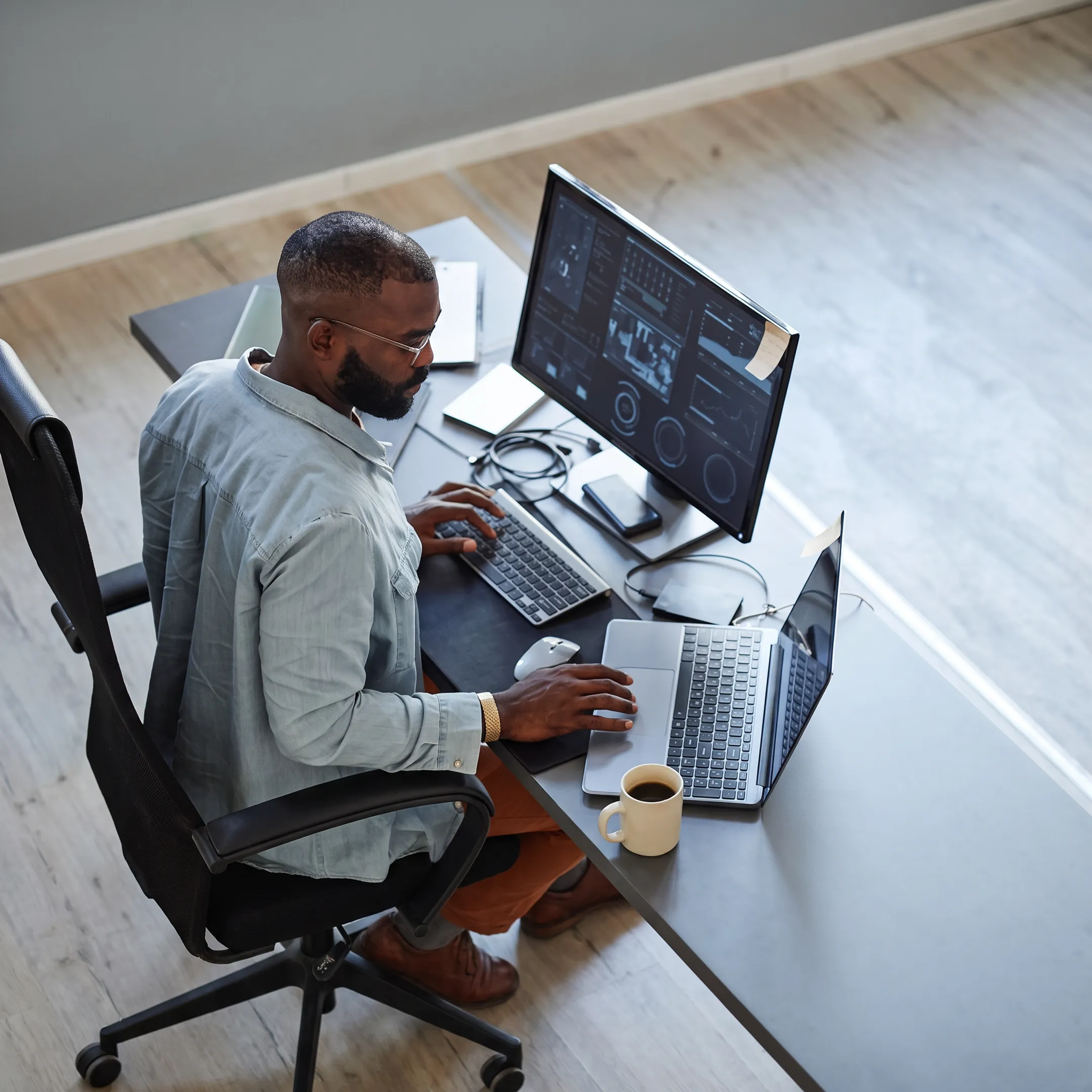 Technician reviewing cybersecurity audit findings on a monitor