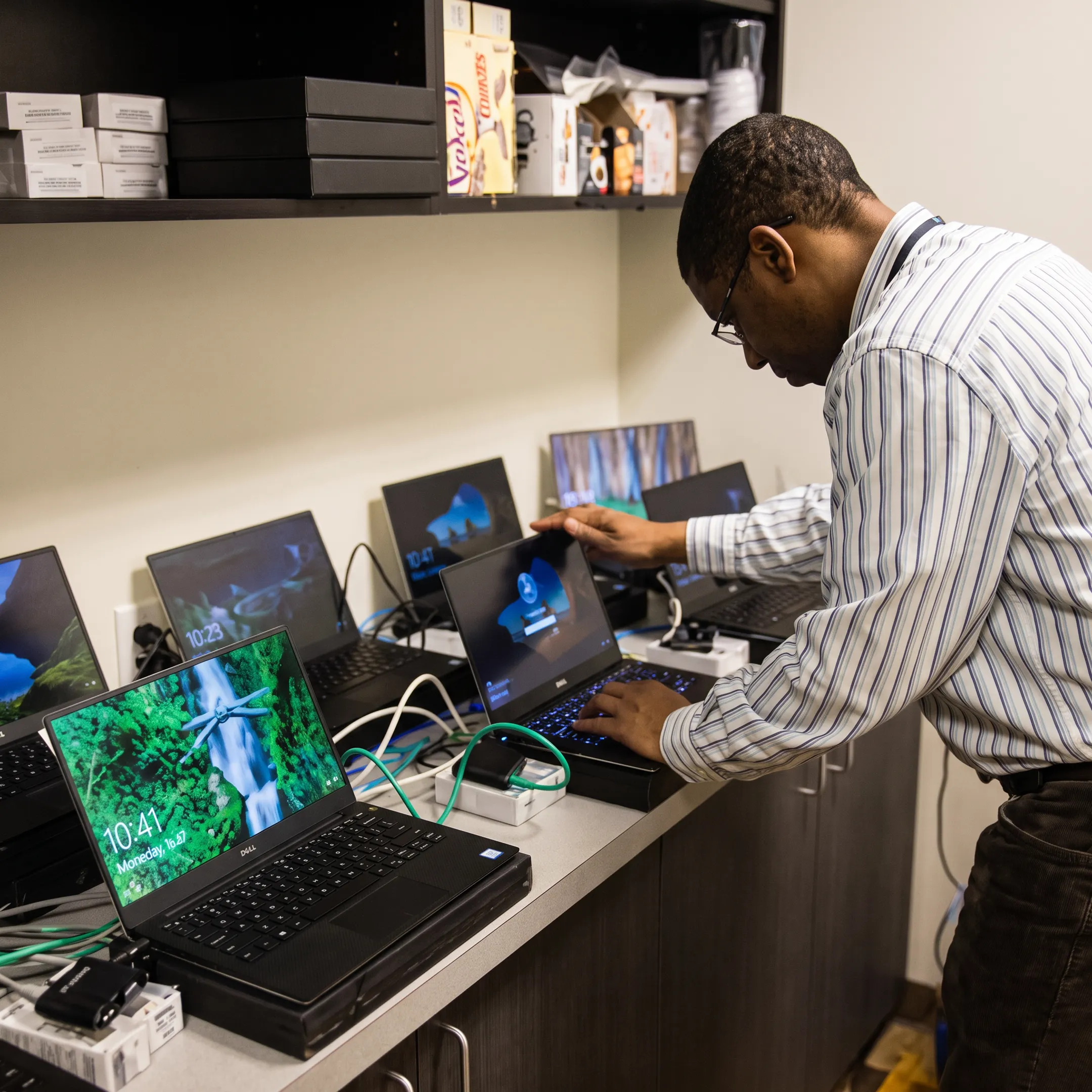 Technician helping startup employees secure cloud systems