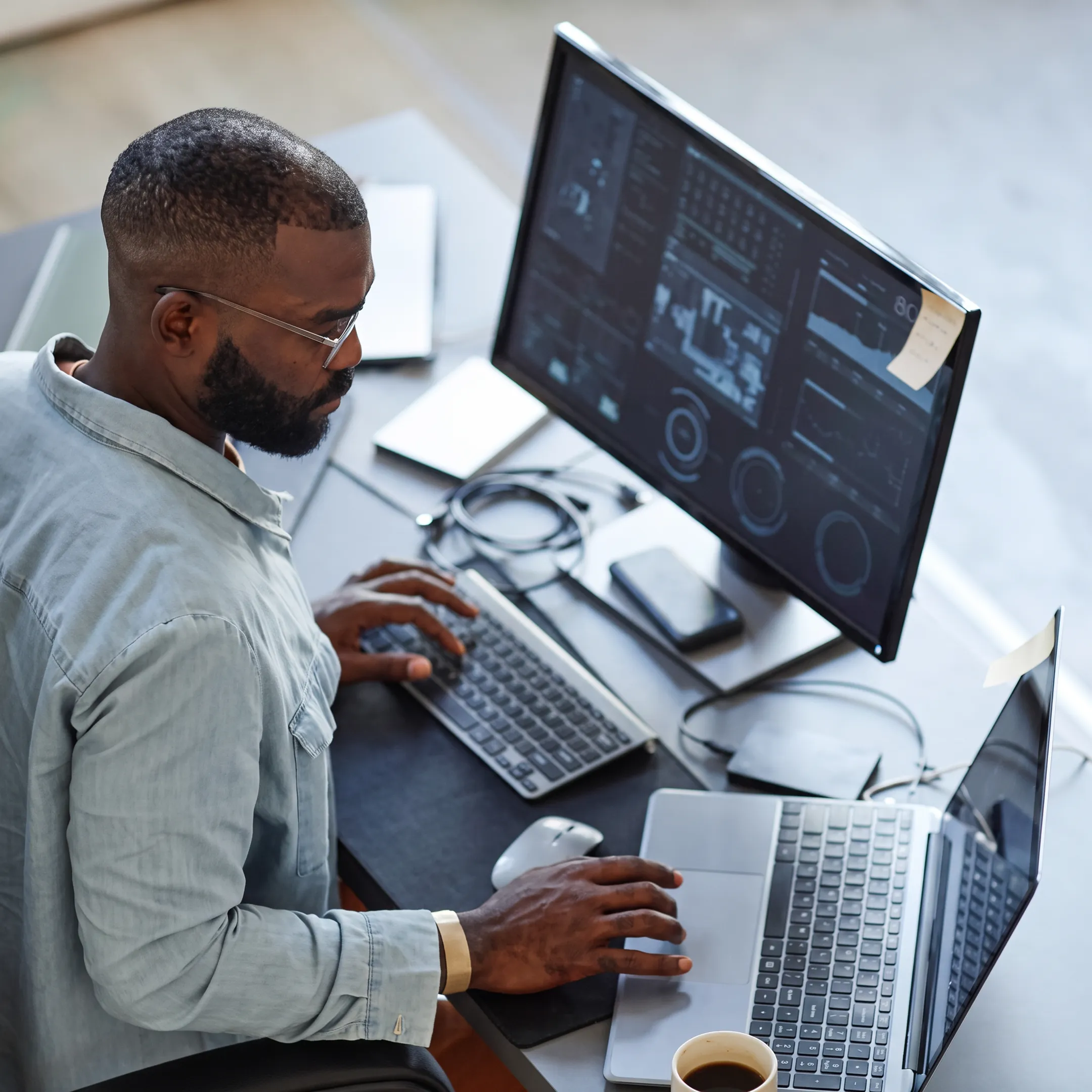 Technician monitoring business applications on multiple screens