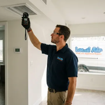 HVAC technician checking residential AC performance