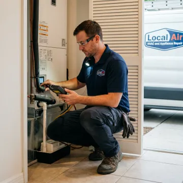 HVAC technician testing an indoor air handler
