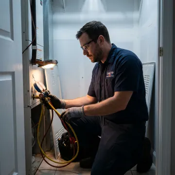 Technician checking an indoor HVAC air handler