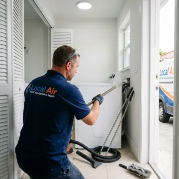 Dryer vent cleaning tools beside laundry appliance