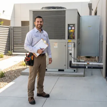 HVAC technician performing maintenance checklist on commercial AC system