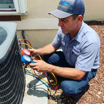 HVAC technician inspecting an emergency AC repair