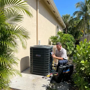AC technician repairing an outdoor unit in Delray Beach