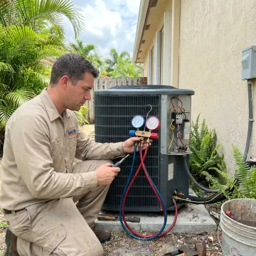 HVAC technician testing an air conditioner