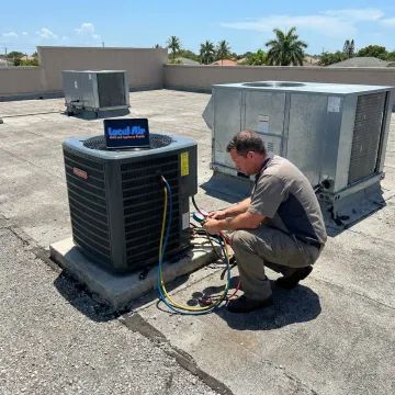 Commercial AC technician servicing rooftop unit