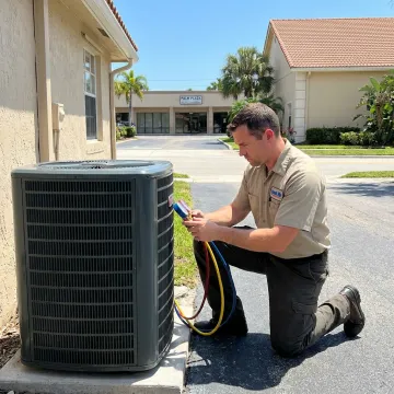 HVAC technician servicing an outdoor AC unit