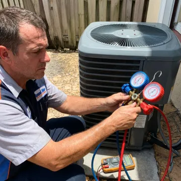 HVAC technician testing AC performance