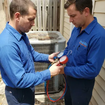 HVAC technician checking AC unit