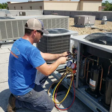 Technician inspecting commercial HVAC components