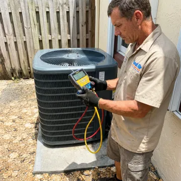 HVAC technician testing AC refrigerant pressure