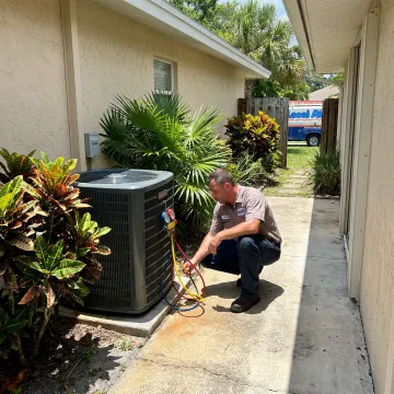 Technician servicing a residential AC unit in Lake Park