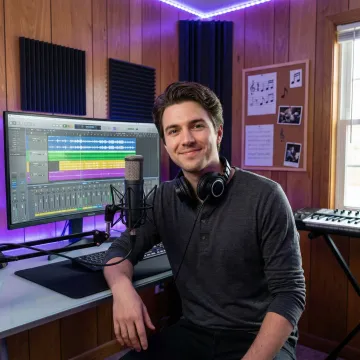 Professional artist in recording studio with production equipment and creative workspace