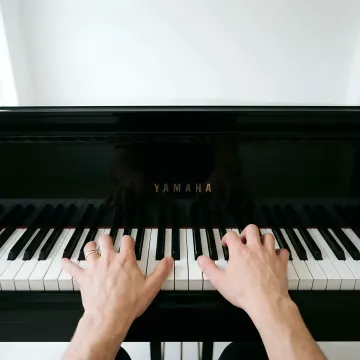 Music professional reviewing Facebook ad performance metrics on laptop