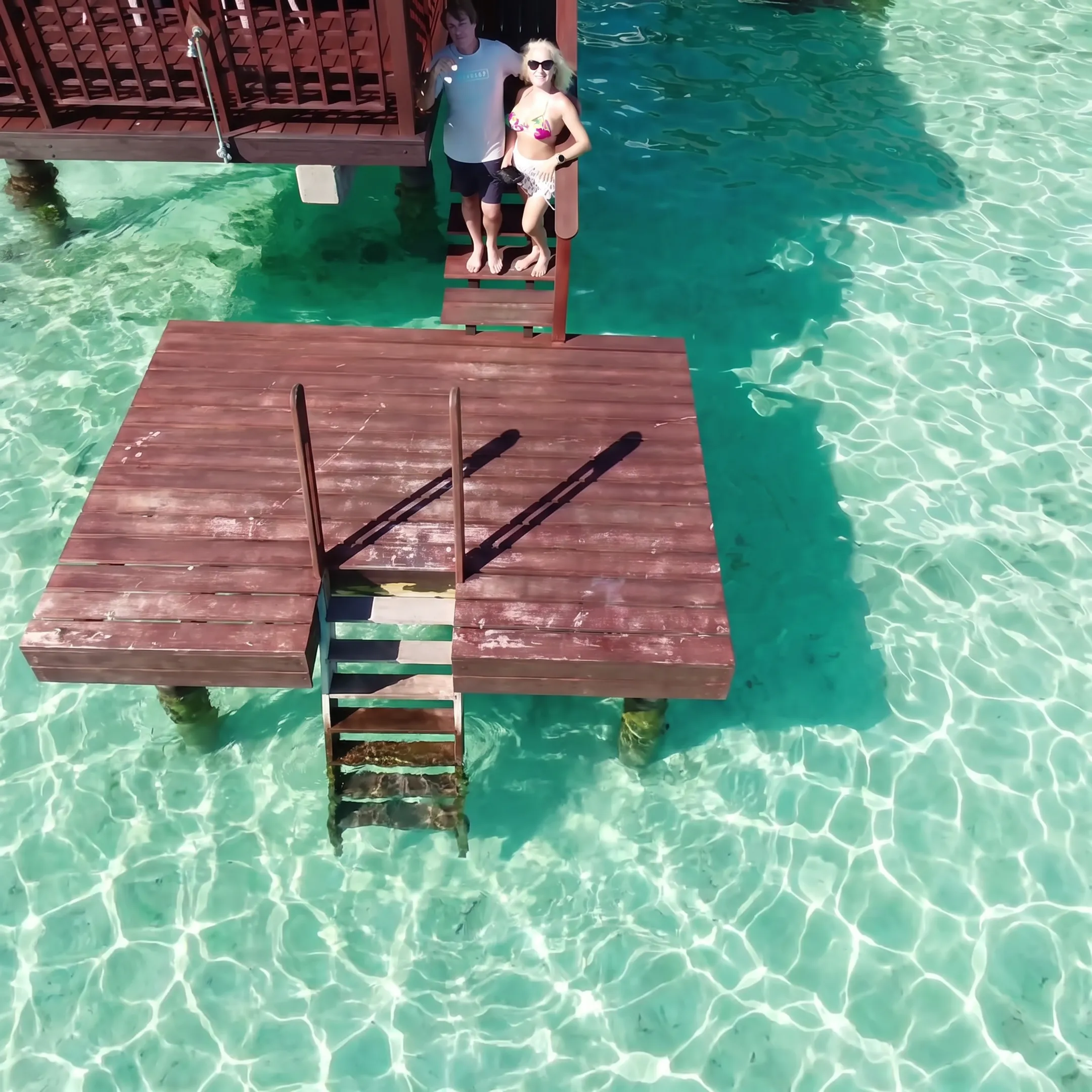 Travel advisor helping couple choose an overwater bungalow vacation