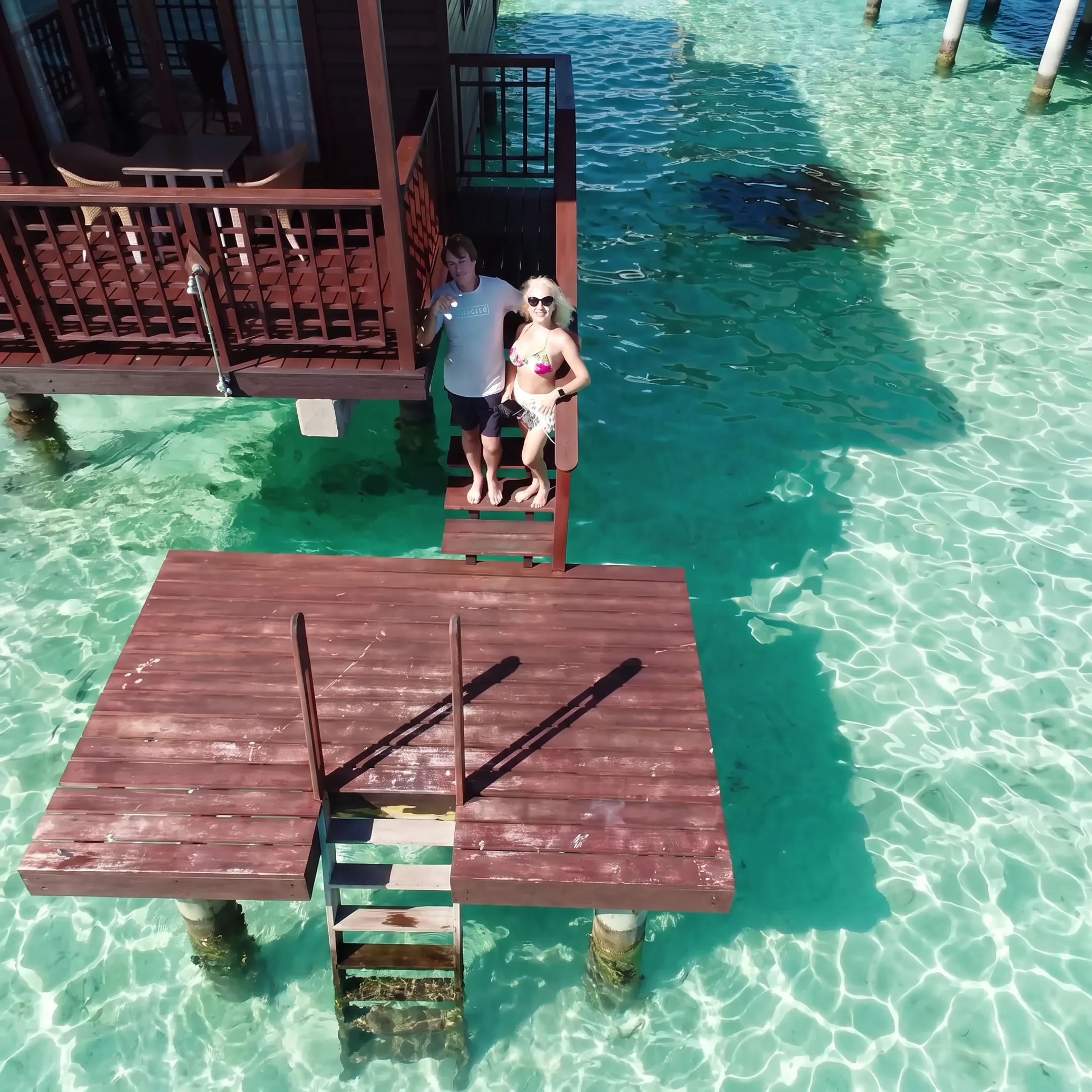 Couple relaxing beside a Bora Bora lagoon during a romantic vacation