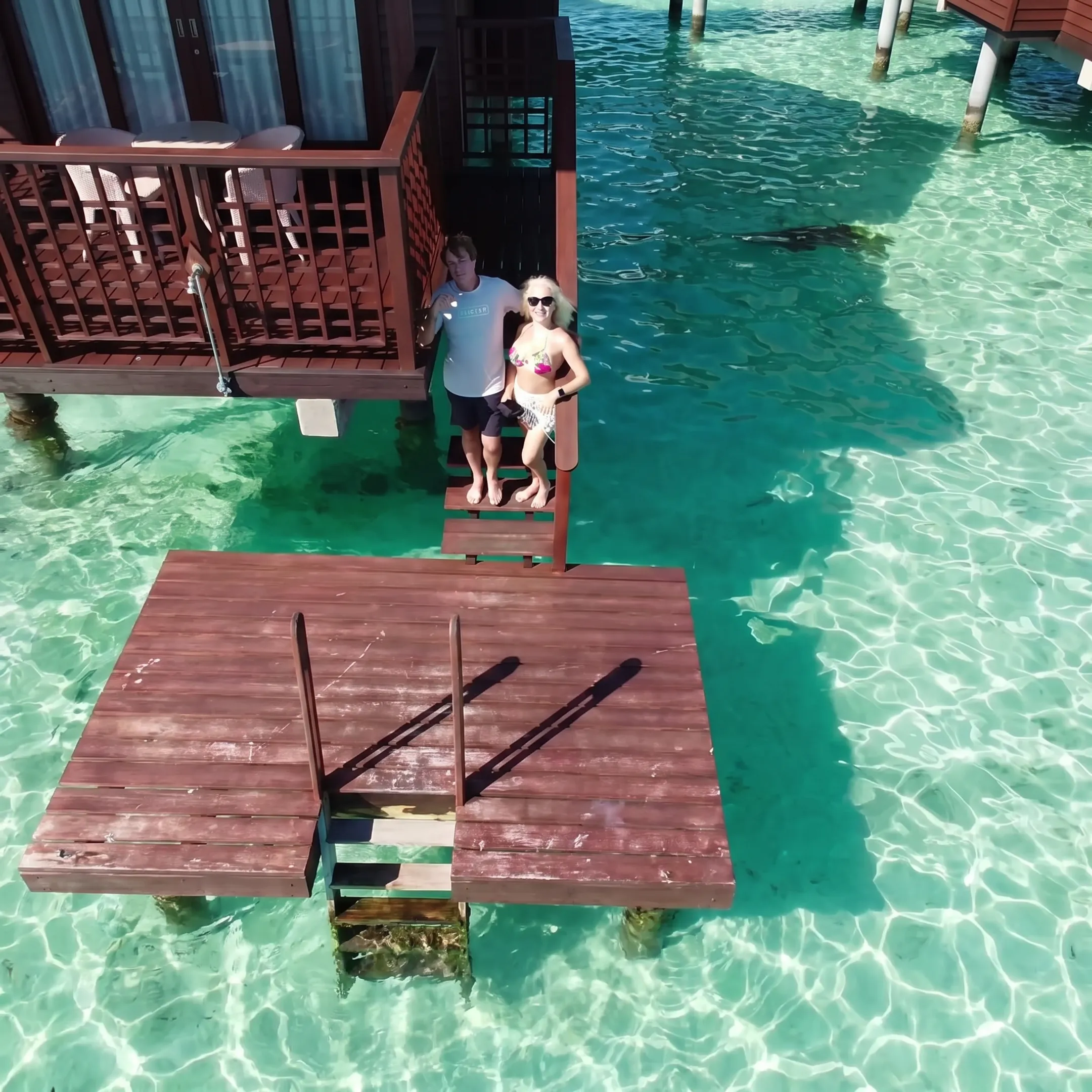 Honeymoon couple viewing a Moorea lagoon from a bungalow