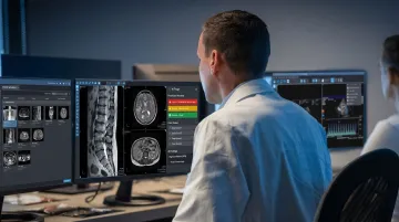 Radiologist reviewing AI-flagged imaging results on hospital PACS workstation screen